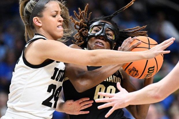 Colorado guard Jaylyn Sherrod (0) drives against Iowa guard Gabbie Marshall (24) during the first quarter of a Sweet Sixteen round college basketball game during the NCAA Tournament, Saturday, March 30, 2024, in Albany, N.Y. (AP Photo/Hans Pennink)