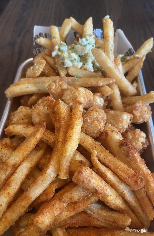 In Campbell, Brew City Grill's potato lineup includes Nashville Fries, front, Tater Tots and Gilroy Garlic Fries with feta cheese. (Linda Zavoral/Bay Area News Group)