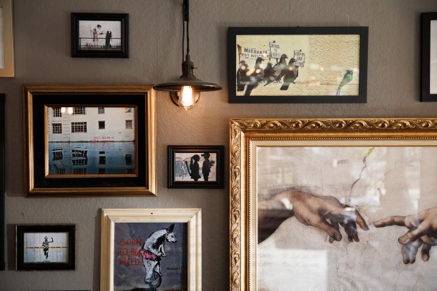 Art pieces by Banksy are displayed inside Mona's Burgers and Shakes in Walnut Creek, Calif., on Tuesday, March 26, 2024. (Dai Sugano/Bay Area News Group)