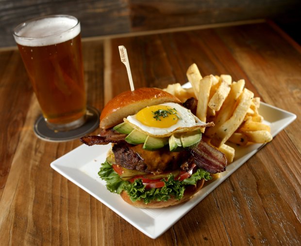 The Baron burger with duck fat fries and a pint of Speakeasy's Big Daddy IPA are photographed at the Beer Baron Bar and Kitchen in Pleasanton, Calif., on Tuesday, Oct. 25, 2016. (Anda Chu/Bay Area News Group)