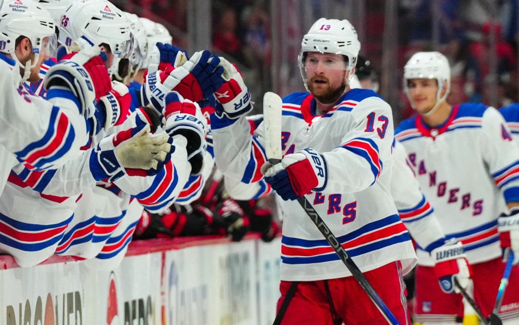 Alexis Lafreniere celebrates with teammates after scoring a third-period goal in the Rangers' 3-2 Game 3 overtime win over the Hurricanes.