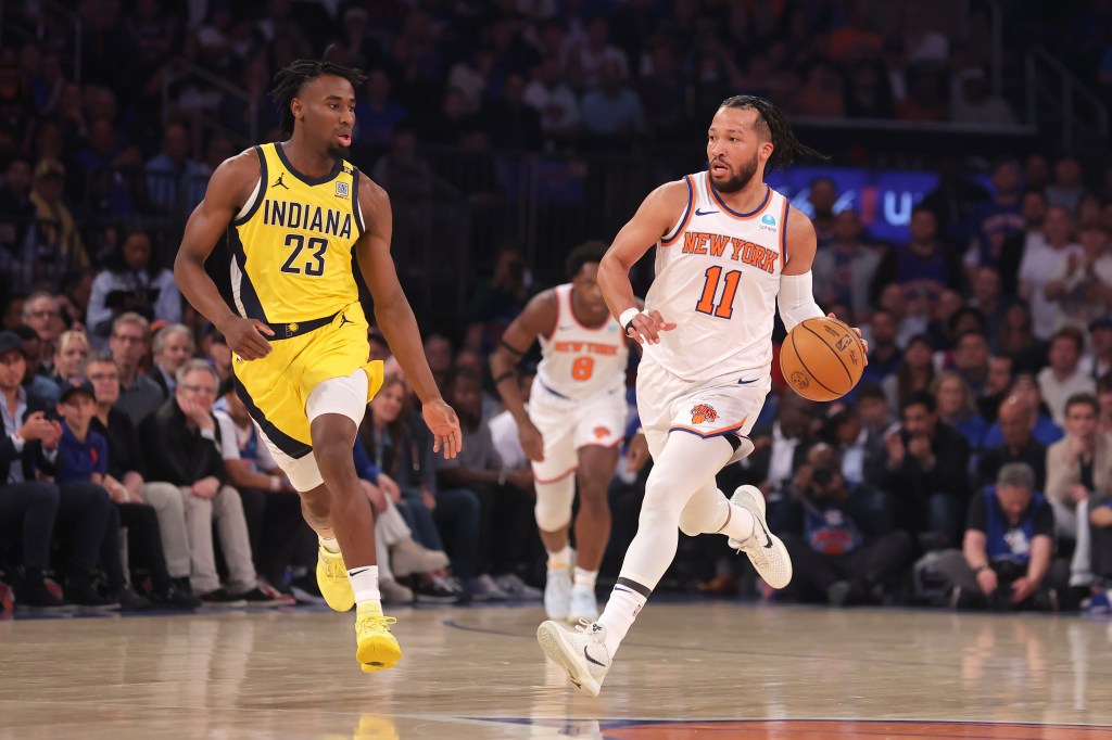 Knicks guard Jalen Brunson (11) brings the ball up court against Indiana Pacers forward Aaron Nesmith (23) during the first quarter of game one