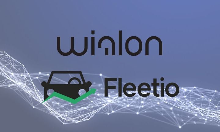 Wialon and Fleetio logos in front of a picture of lines that connect.